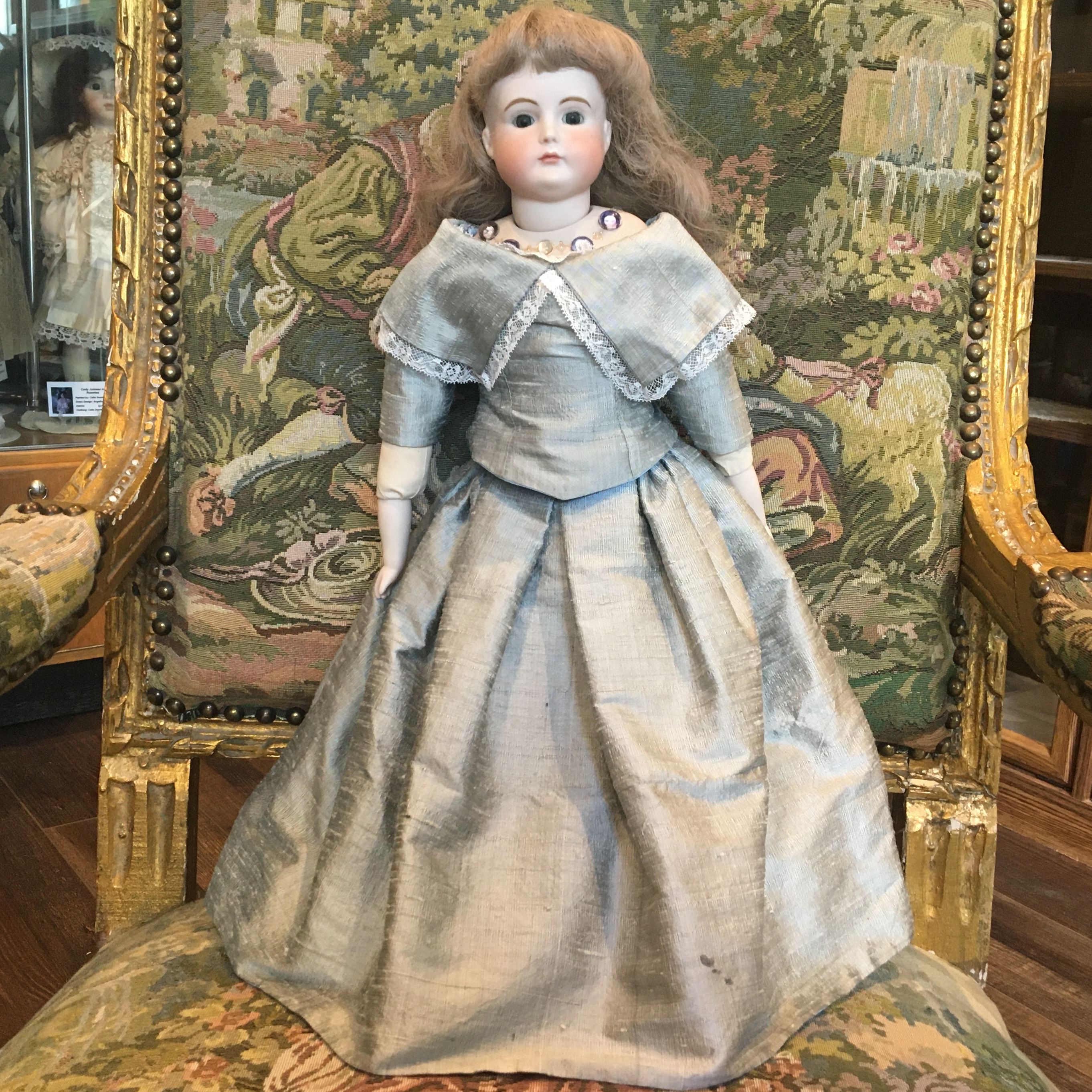 Reproduction XI Girl with inset cabochons around collarbone, depicting other dolls, front view