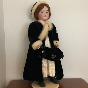 Reproduction Rosalind doll in a black fur coat with white trim, front view