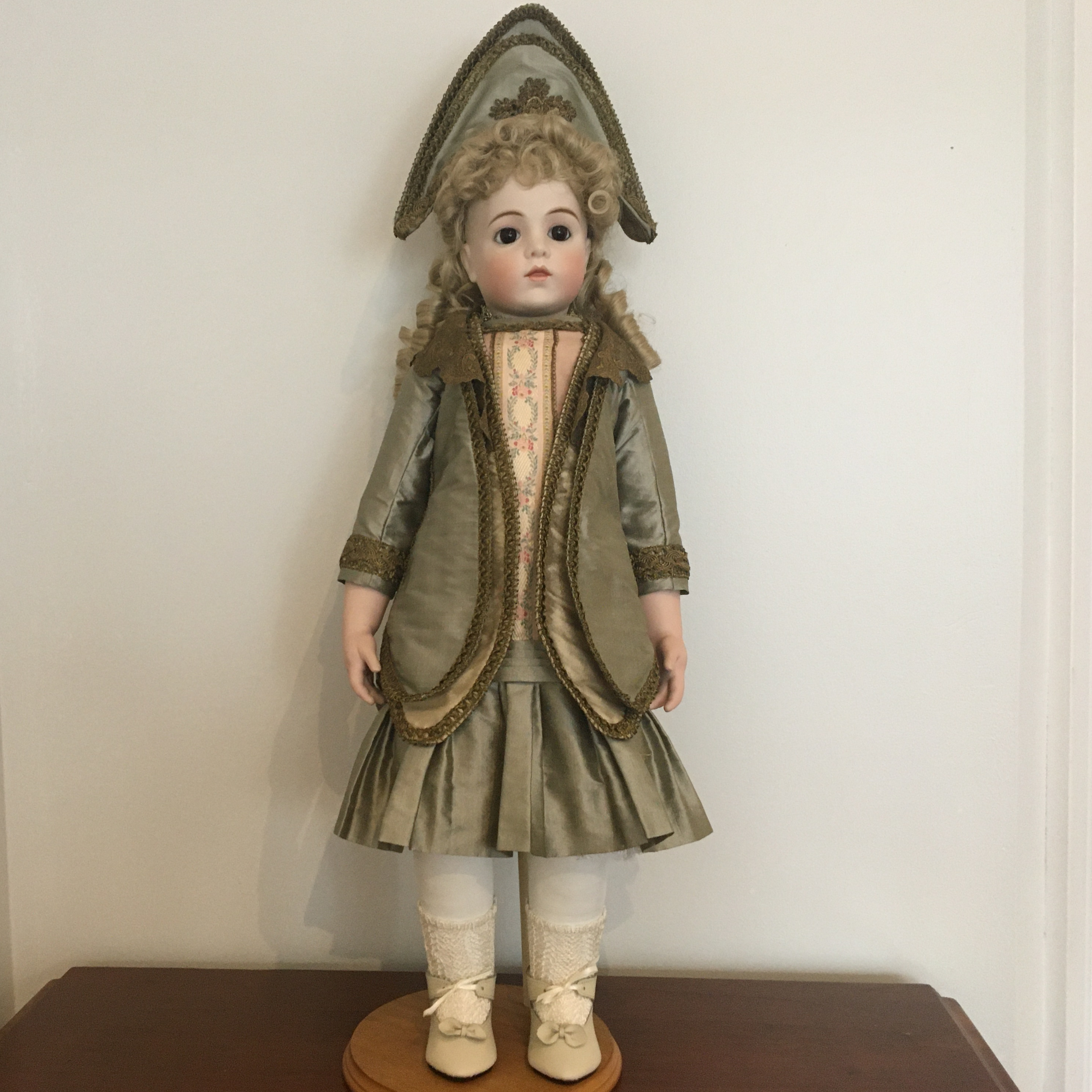 29-inch reproduction Bru doll in elaborate olive green dress and matching hat designed by Kristin Thor, front view
