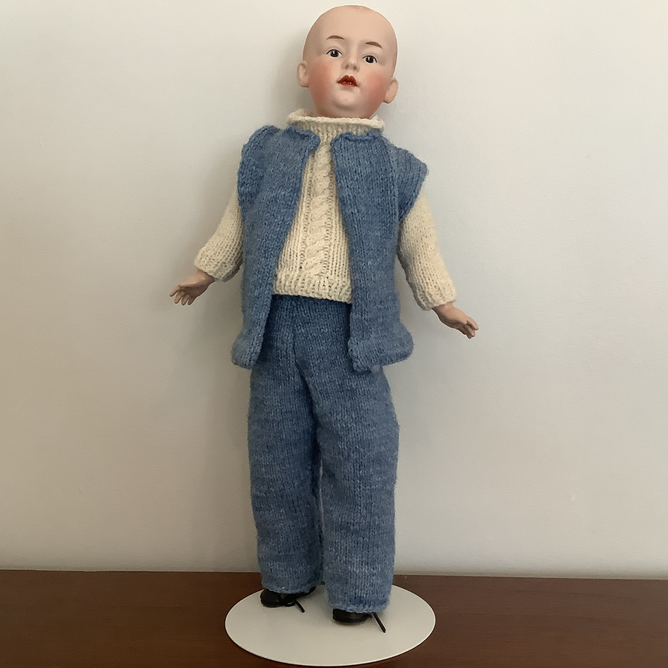 Reproduction Johann doll in blue knit vest and trousers with white cable knit shirt, front view