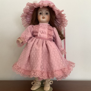 Modern doll in pink dress with long reddish-brown hair