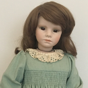 21-inch modern doll in green dress with long brown hair