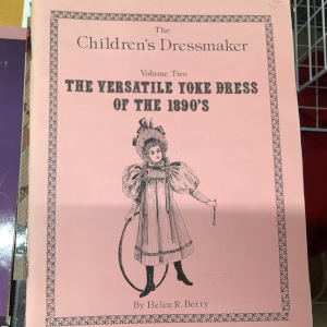 Children's Dressmaker book featuring a woodcut of a young girl wearing a yoke dress