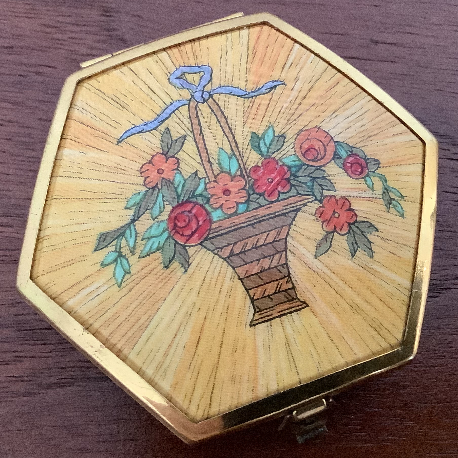 Compact cover depicting a tall, narrow basket full of flowers