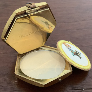 Small makeup compact depicting a basket of flowers