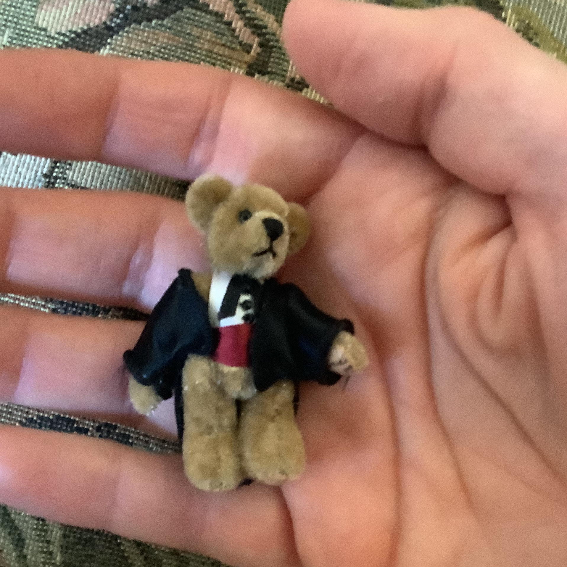 small teddy bear doll in suit jacket and tie with jointed arms and legs