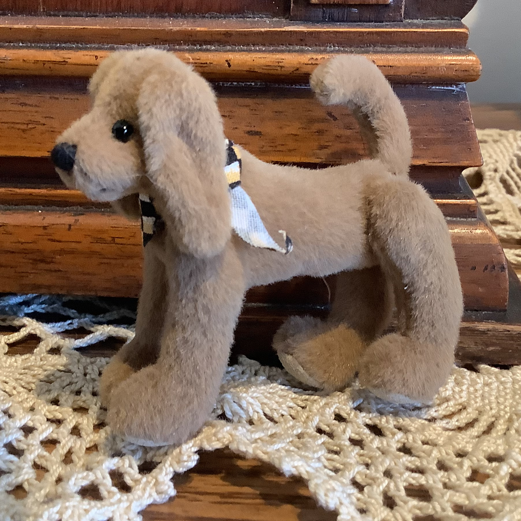 Small brown plush dog with jointed legs