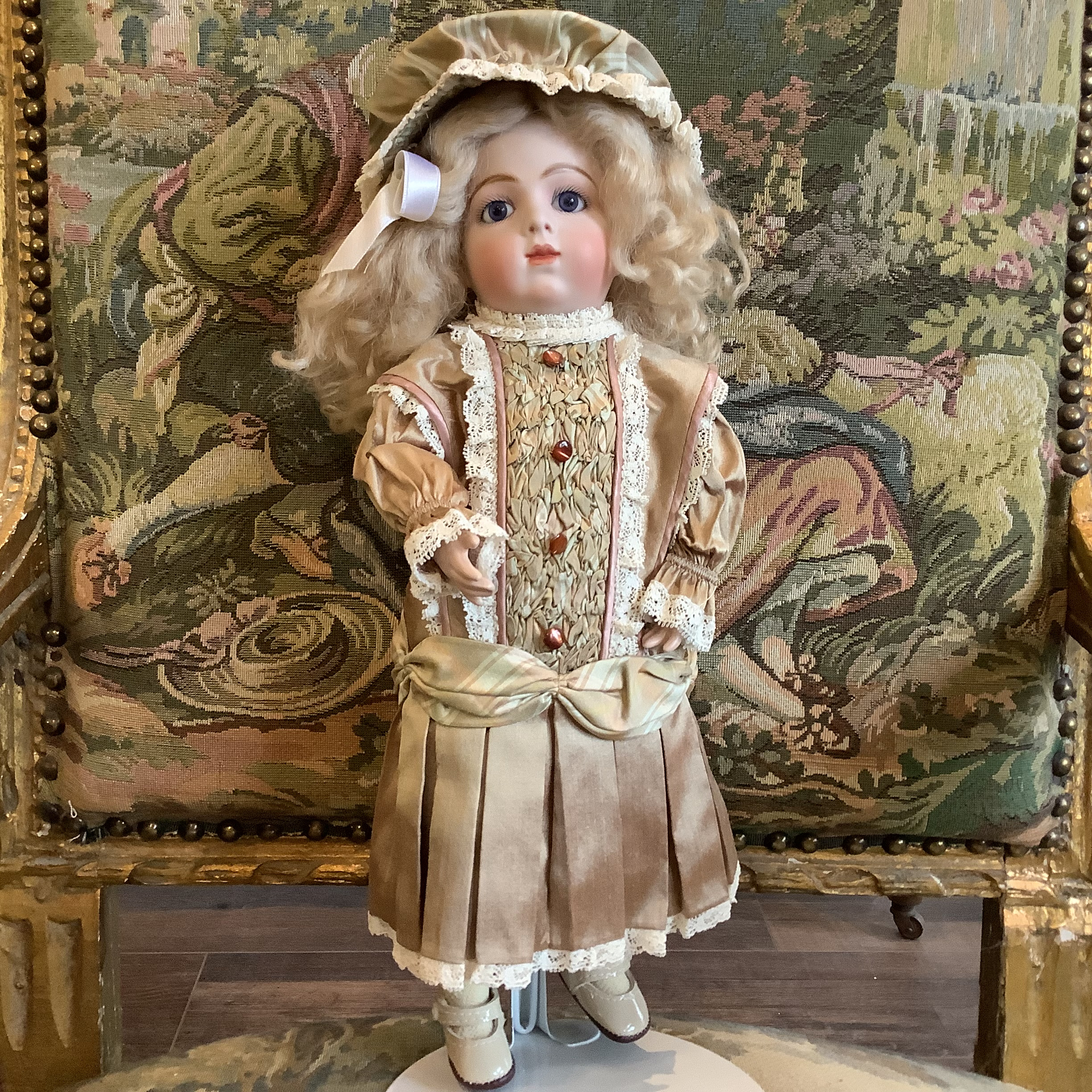 Doll in a beige suit with long, curly blond hair