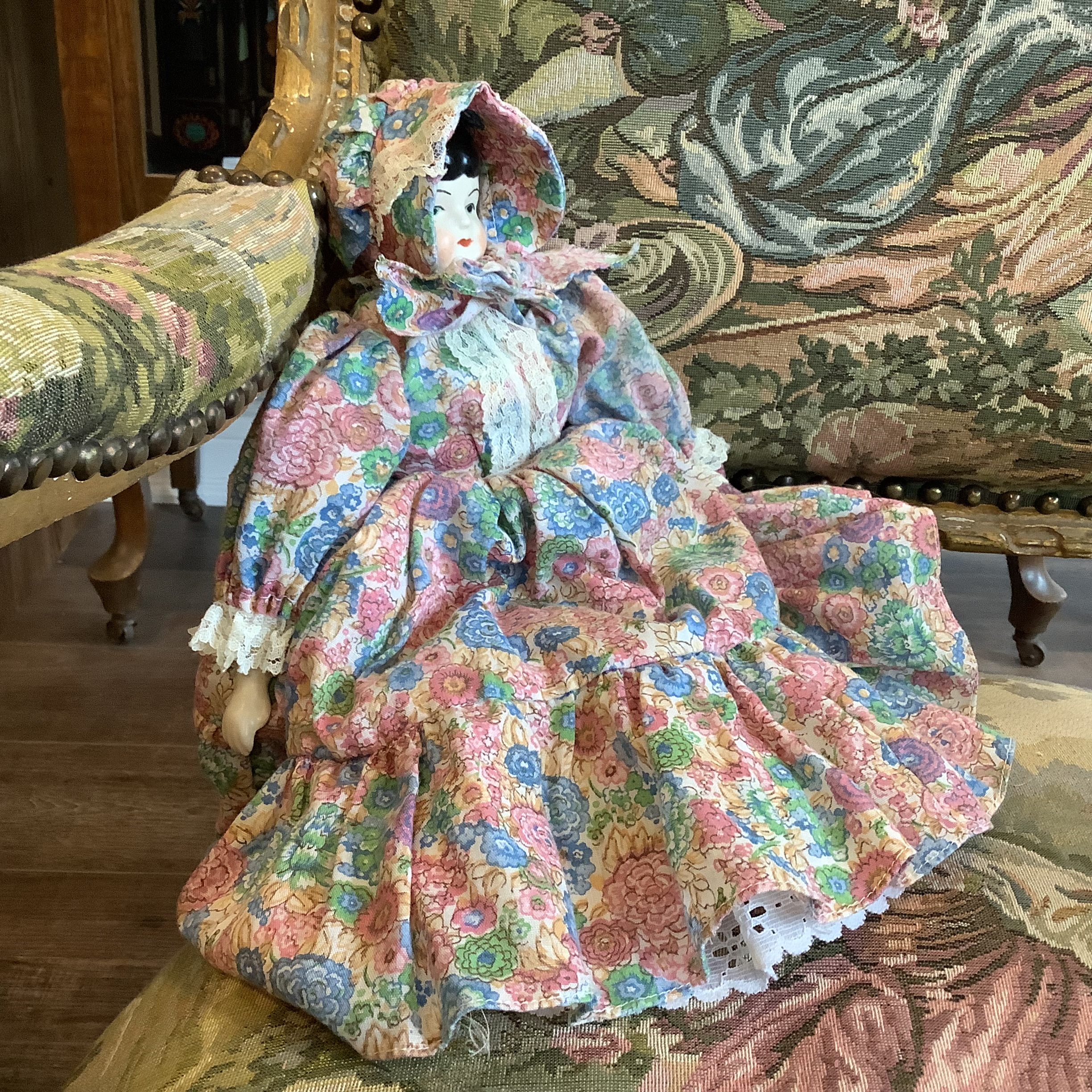 Side view of china doll showing large bonnet that obscures face from the side