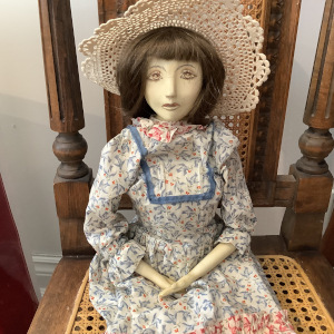 Wooden doll in calico dress with lace hat
