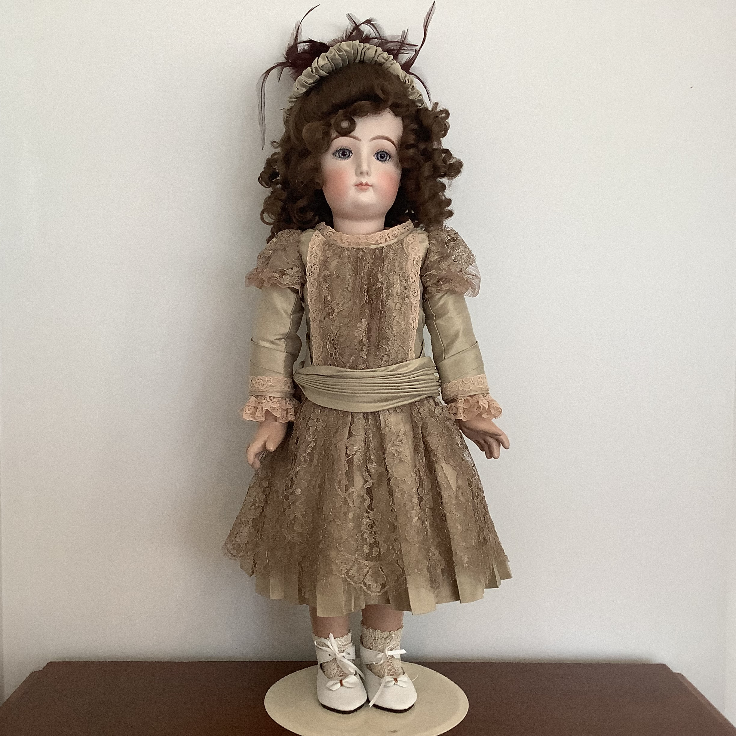 26-inch reproduction AT in taupe dress and matching velvet hat with dark brown feathers, front view