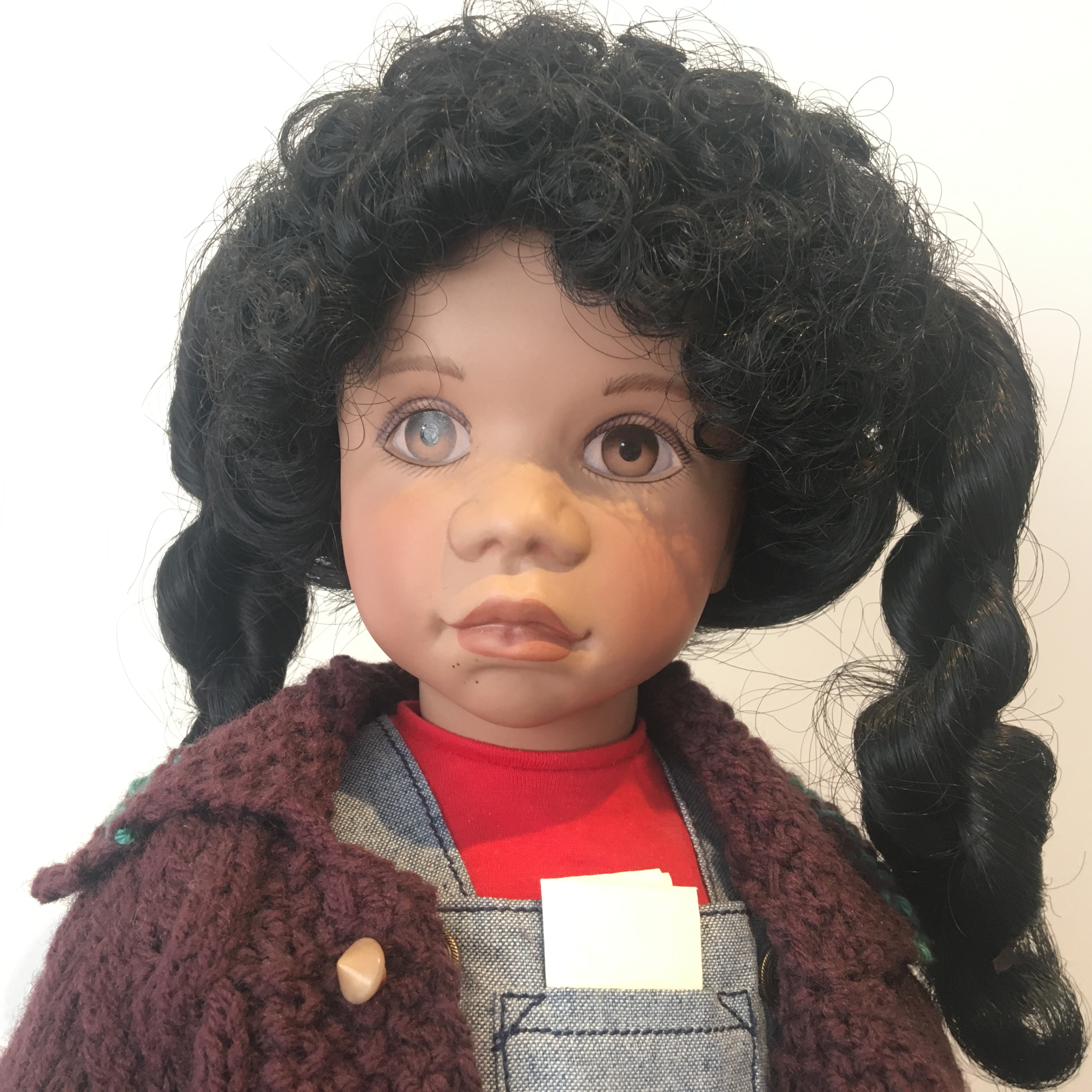 18-inch modern black Rudy doll with twisted pigtails, adorable brown sweater and denim overalls
