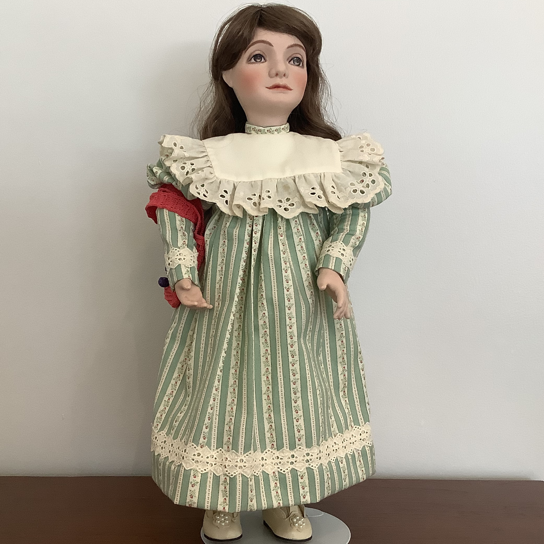 19-inch sculpted Mary Jo doll with painted eyes and long brown hair in a green dress with white eyelet-trimmed yoke