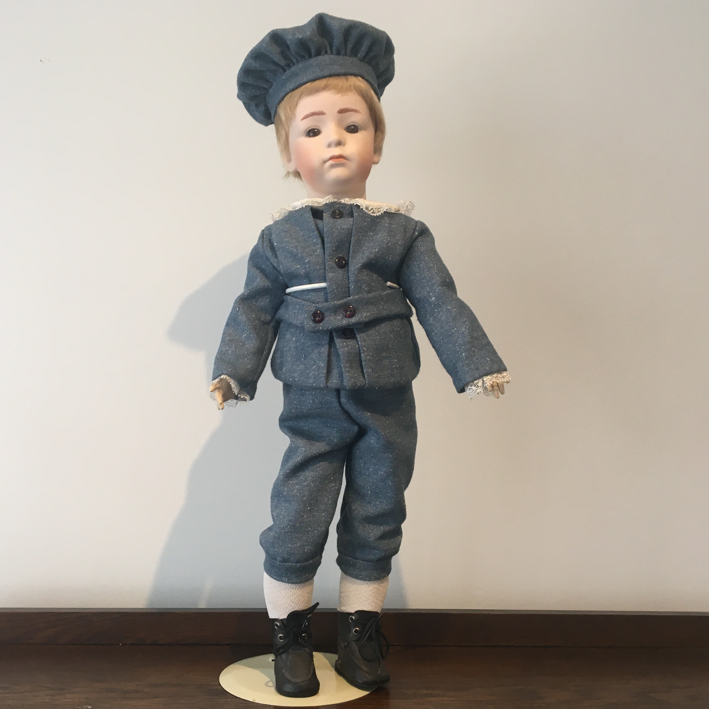 26-inch modern boy doll with short blond hair and a blue tweed suit and hat