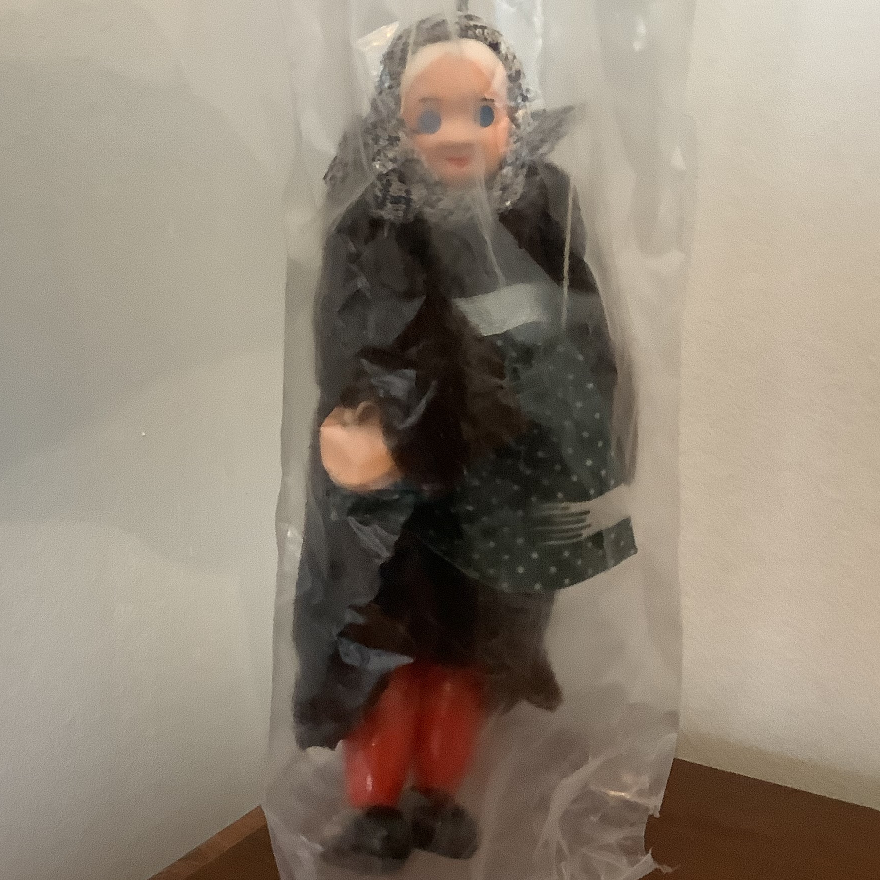 Puppet of old lady in black dress and grey shawl