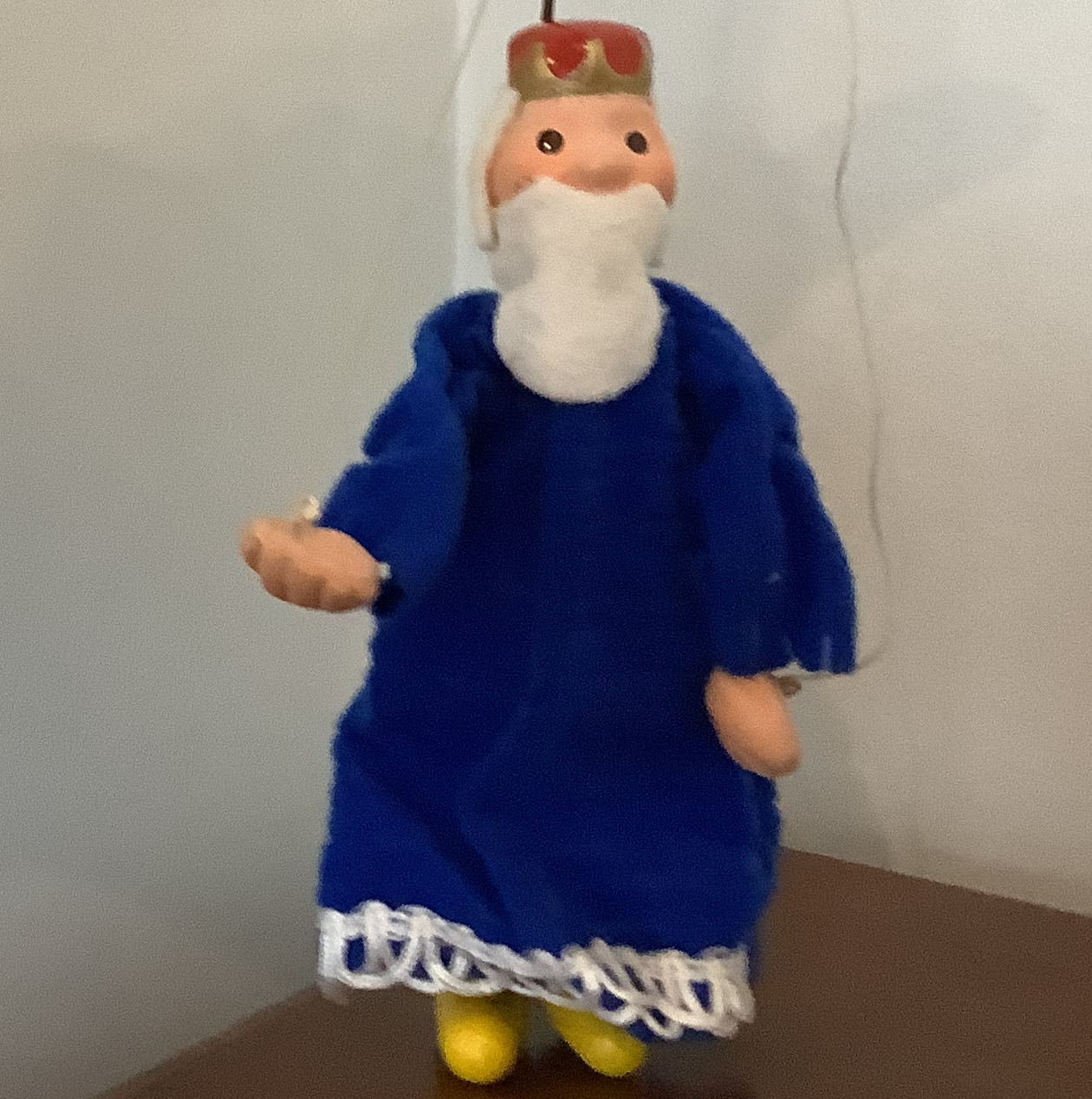 Puppet of old man wearing red crown and blue robe