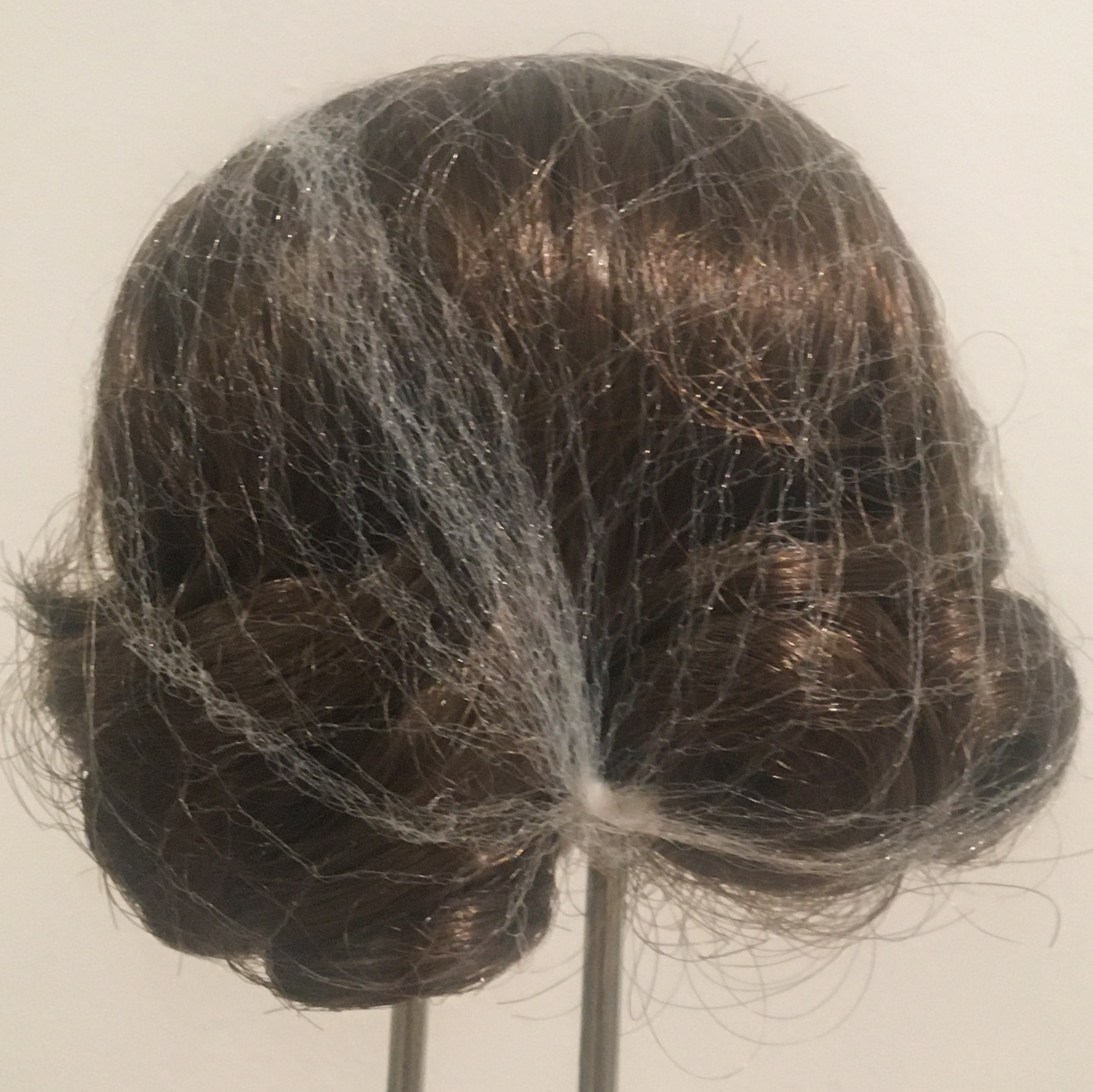 Small, dark brown wig, straight with curled ends, contained in a hair net