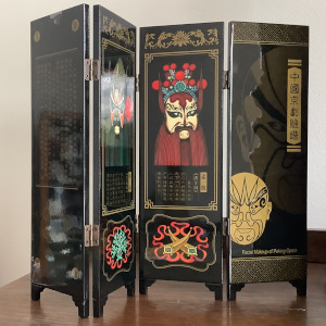 Black laquered miniature screen painted with elaborately made-up characters and descriptions in Chinese from the Peking opera