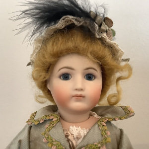 12-inch reproduction Stobe doll in green dress and matching hat