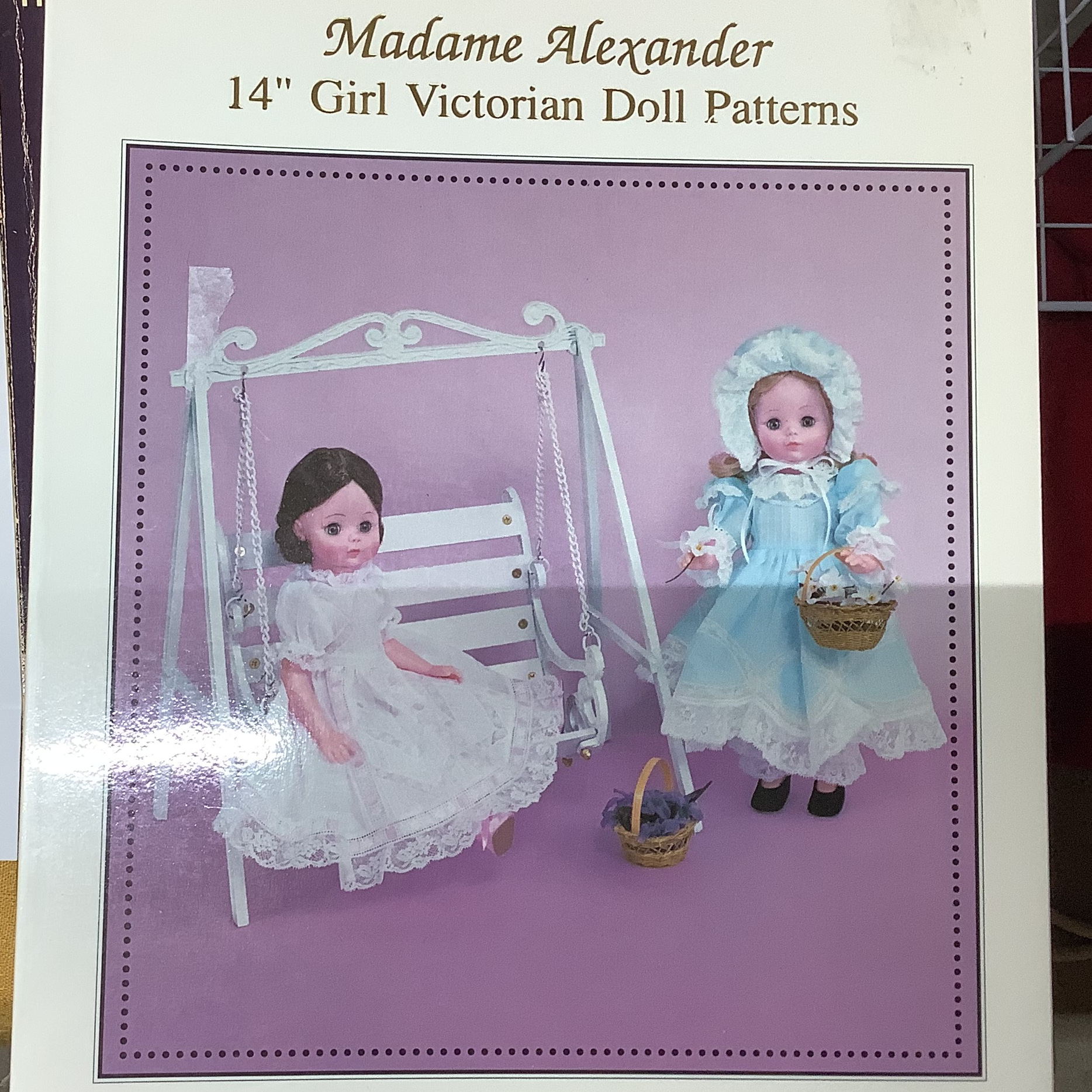 Softcover book depicting two commercially-produced child dolls wearing nostalgic clothing