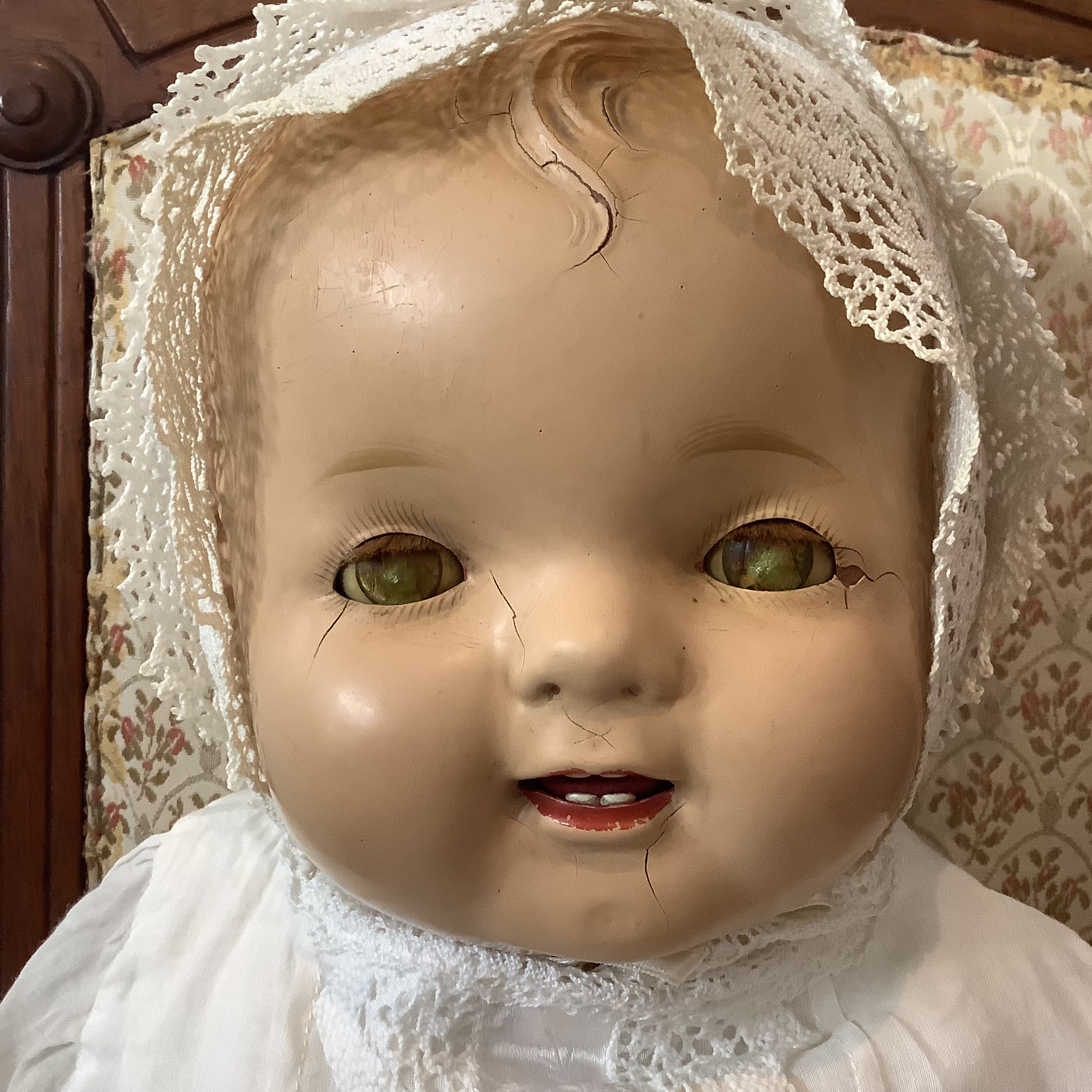 Vintage baby doll face with severe fading in eyes and cracks in face