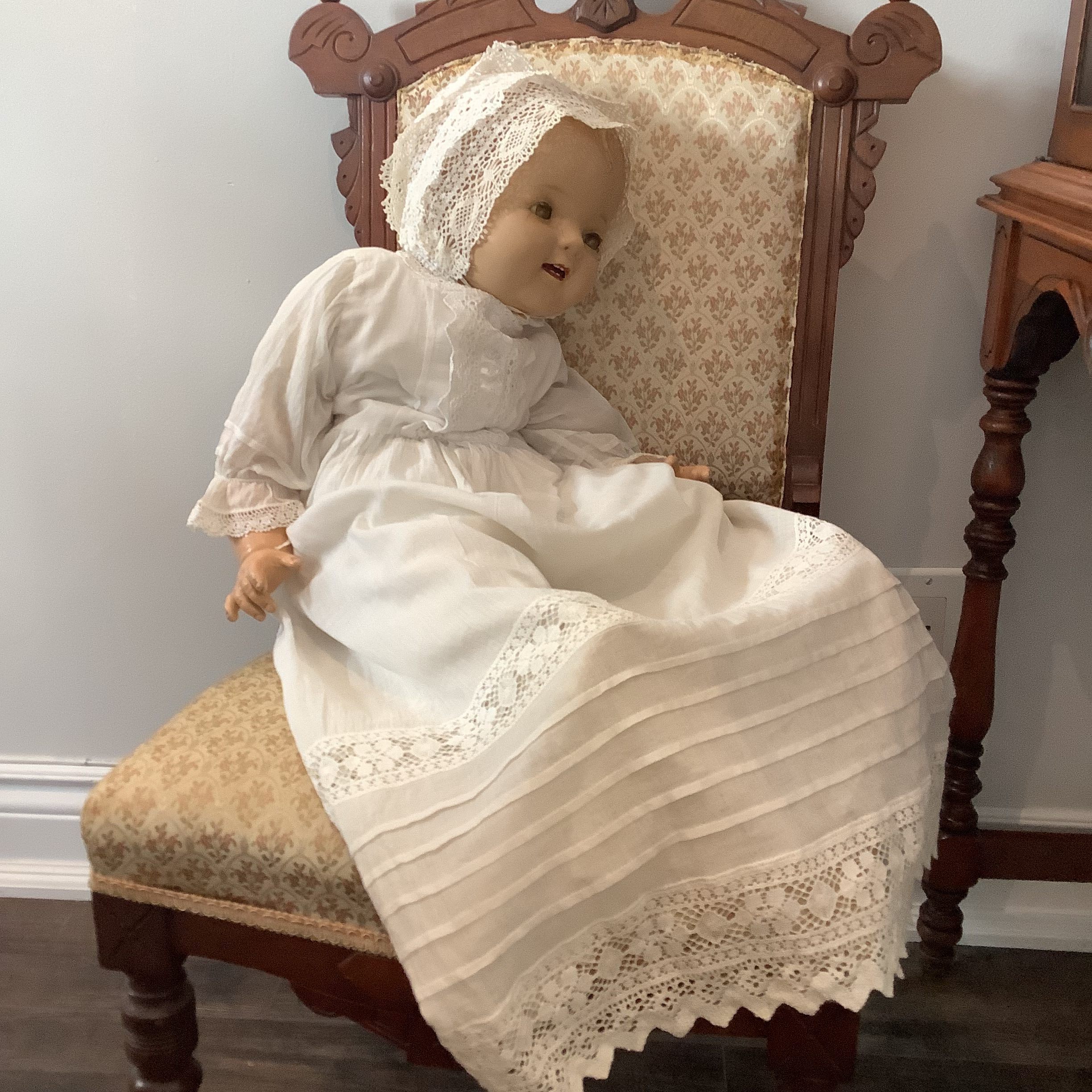 Vintage baby doll in chair