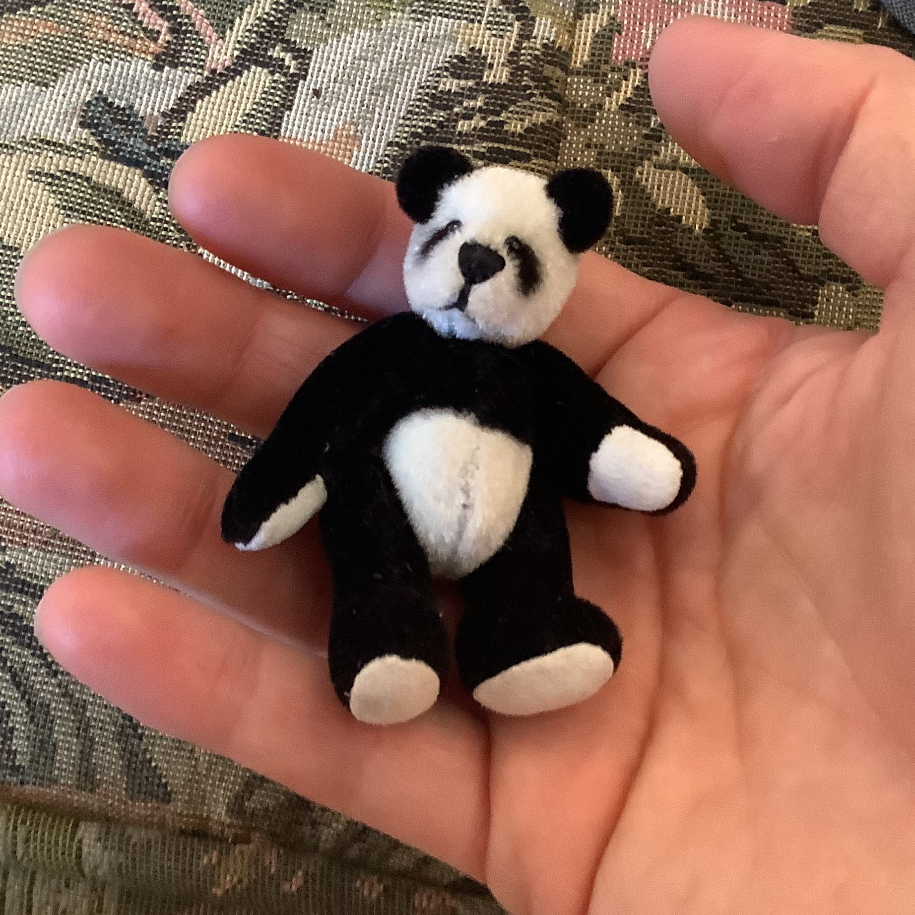 small panda doll with jointed arms and legs