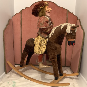 Horseman doll with comically grotesque caricature face in three options, seated on an antique rocking horse