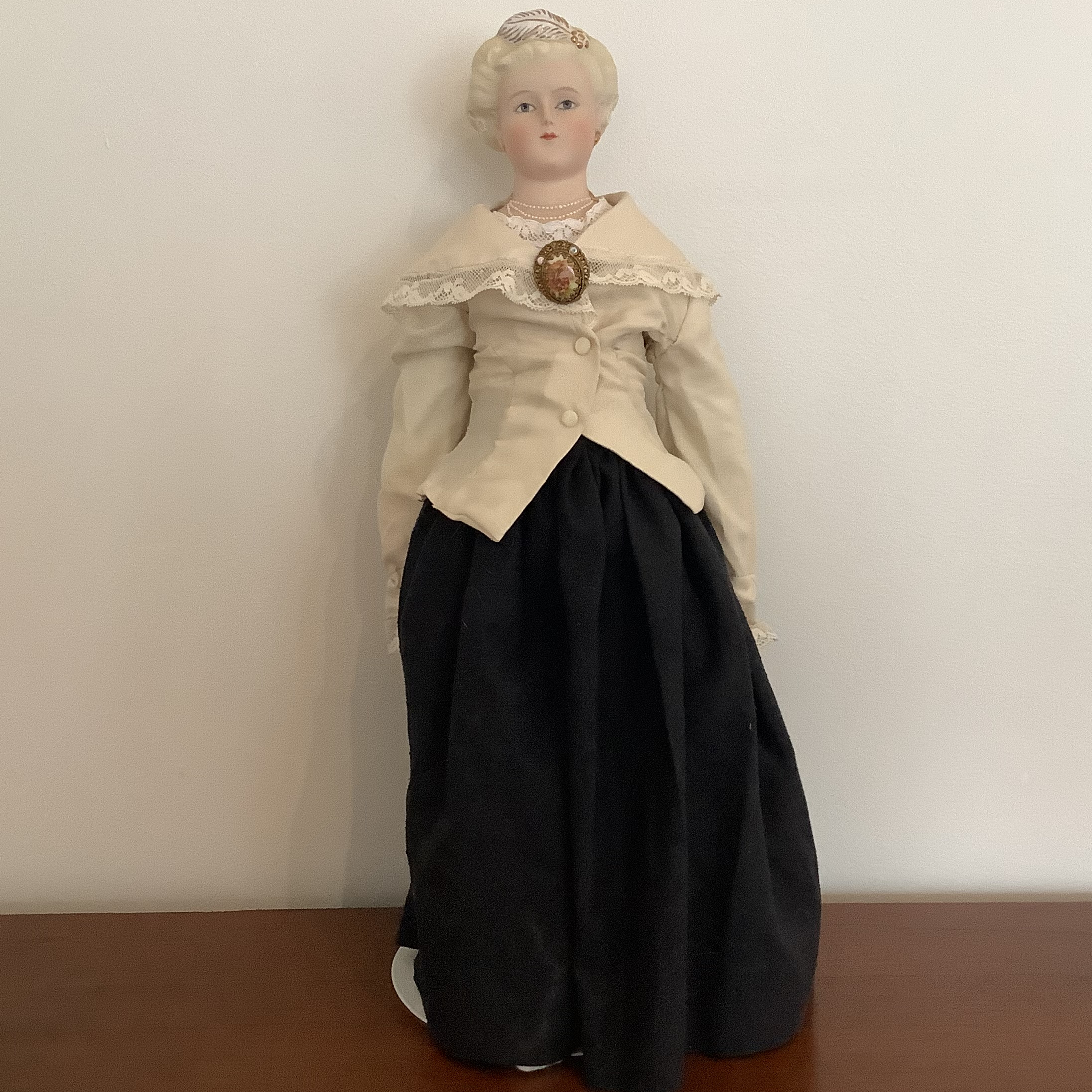 Reproduction Parien lady doll with painted jewels in hair and around neck, front view