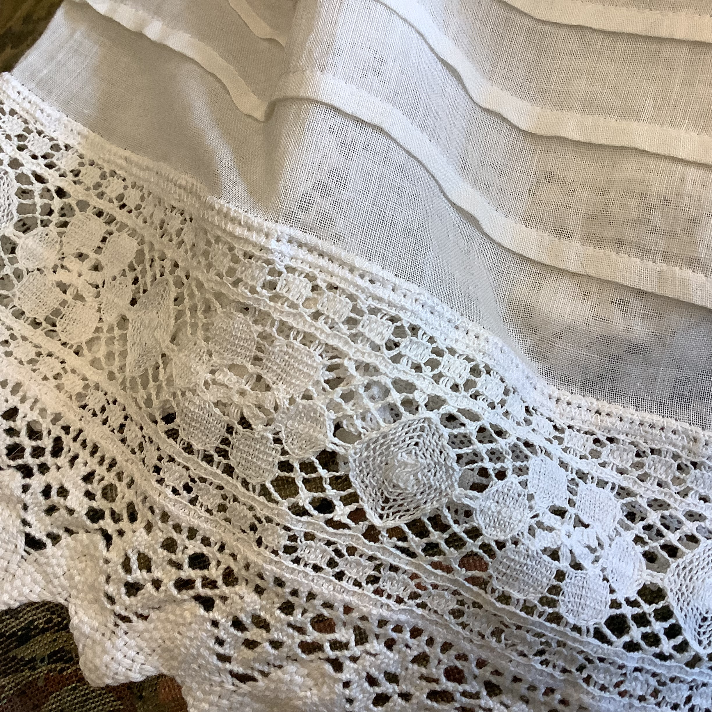 Lace cuff of christening gown with composition hand showing many years of wear